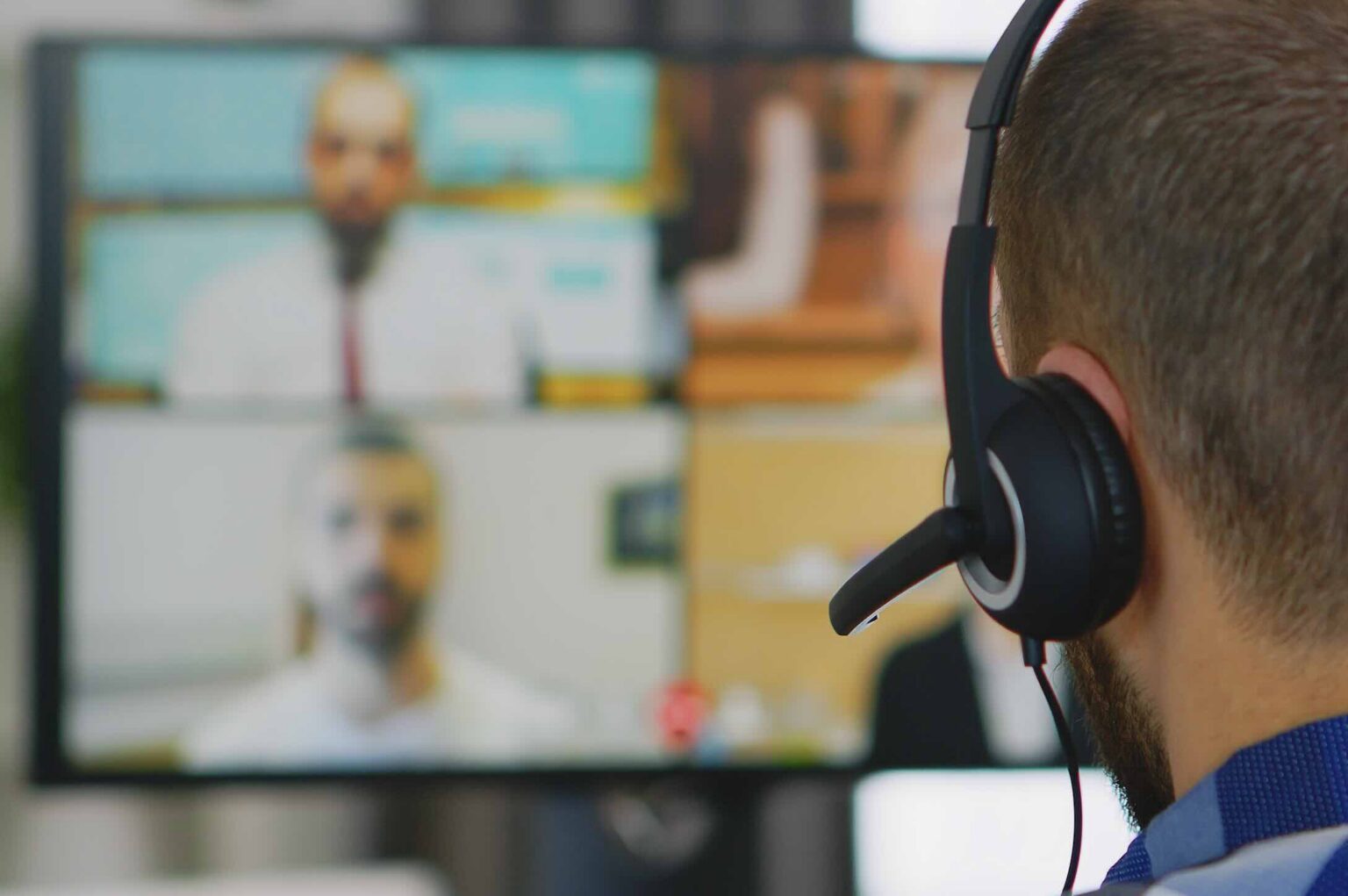 Over-the-shoulder view of a man giving a virtual deposition on a Zoom conference call | Daniel Stark Injury Lawyers