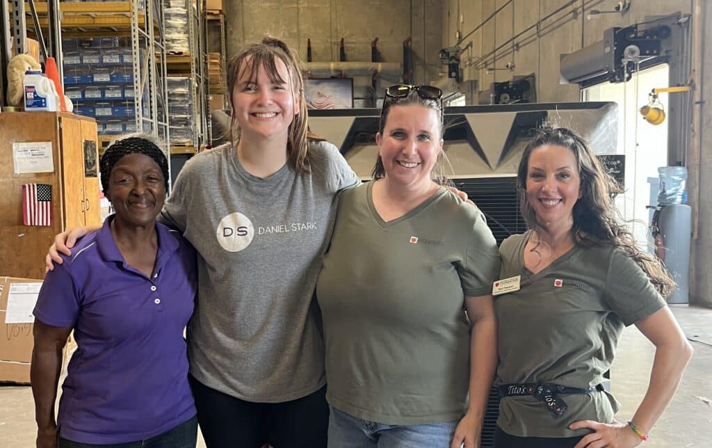 Four women including Daniel Stark Injury Lawyers volunteer at Round Rock ISD warehouse, packing school supplies for the 2025 back-to-school season | Daniel Stark Law