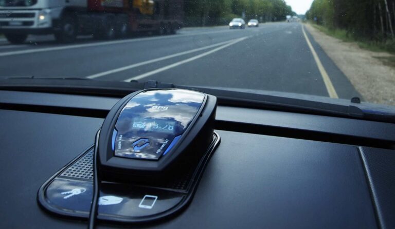 A police radar detector on the dash of a car driving down a country road | Daniel Stark Injury Lawyers