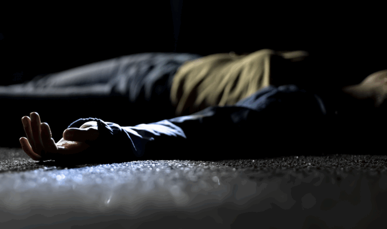 Spotlight illuminating the hand of a woman lying on the ground, representing involuntary manslaughter | Daniel Stark Law