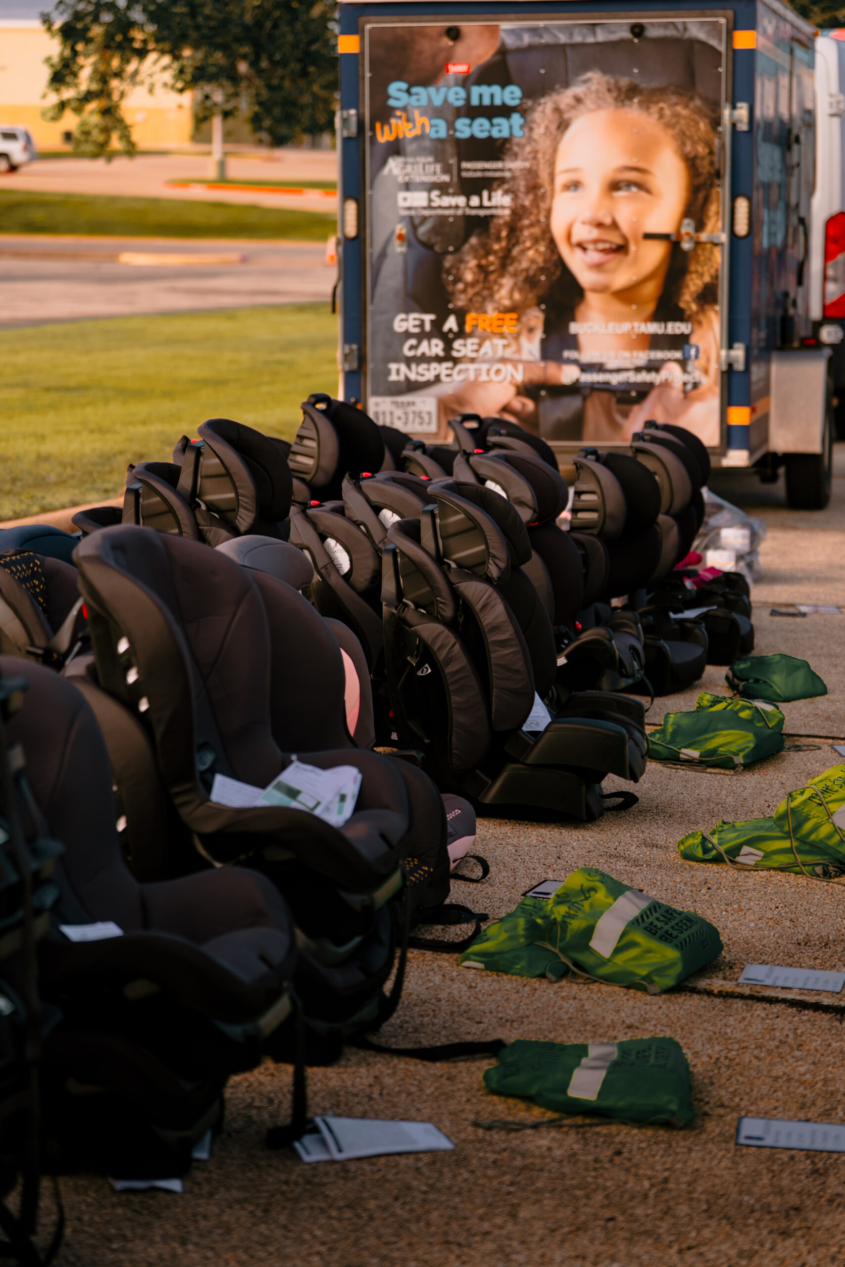 Car seats lined up in front of TxDot's Save Me (with) a Seat truck at Daniel Stark's 18th Annual Car Seat Safety Event in Bryan, Texas | Daniel Stark Law