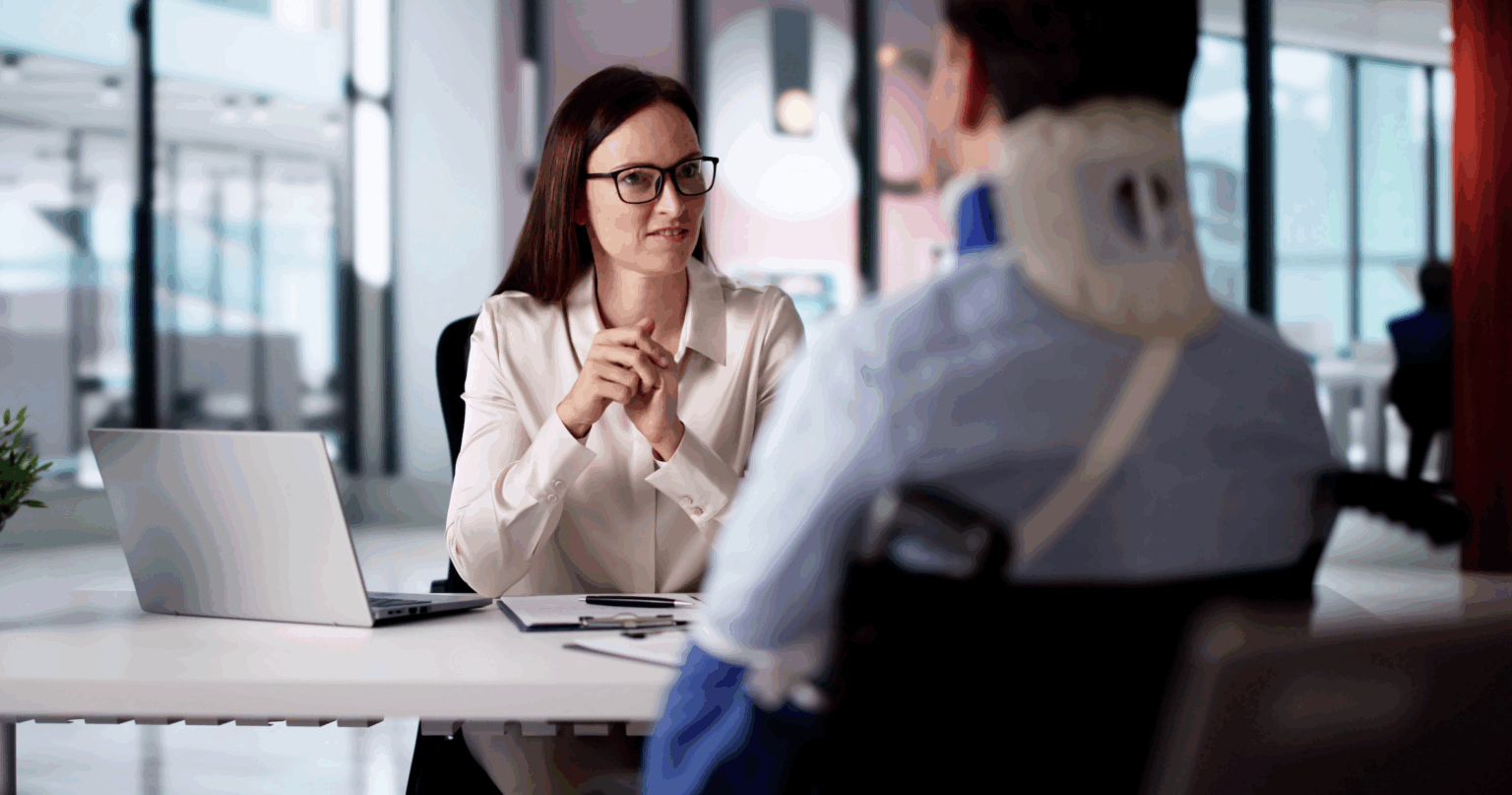 Personal injury lawyer advising an injured client wearing a neck brace after an accident | Daniel Stark Law