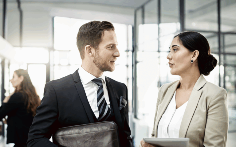 Paralegal speaking with an attorney in a public area of their law firm | Daniel Stark Injury Lawyers