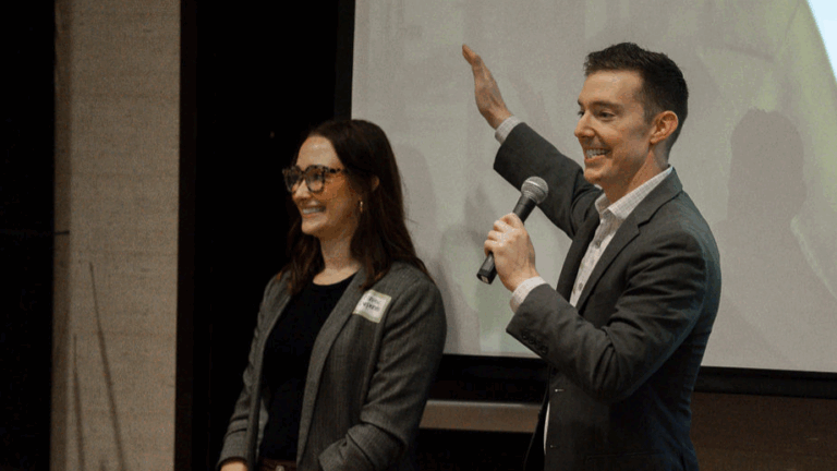 Casey Kelly standing in front of a screen with another Daniel Stark Attorney sharing a client story | Daniel Stark Injury Lawyers