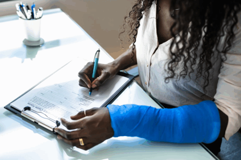 Woman with arm injury filling out a Texas workersโ compensation claim form | Daniel Stark Injury Lawyers