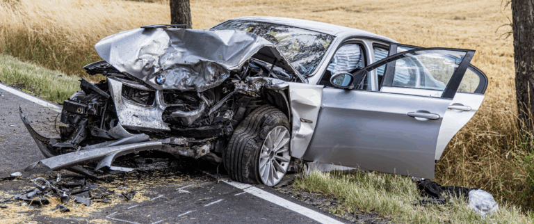 silver car with heavy property damage after a car accident | Daniel Stark Injury Lawyers