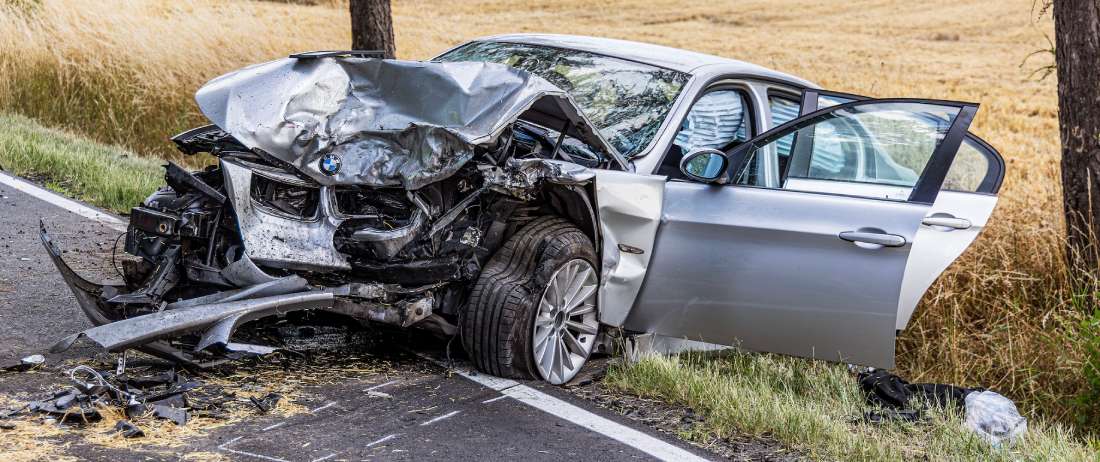silver car with heavy property damage after a car accident | Daniel Stark Injury Lawyers