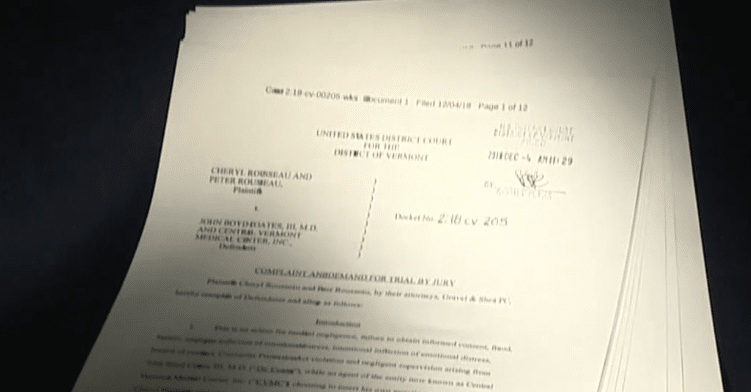 Stack of printed legal documents from the Rousseau fertility fraud lawsuit on a black background | Daniel Stark Injury Lawyers