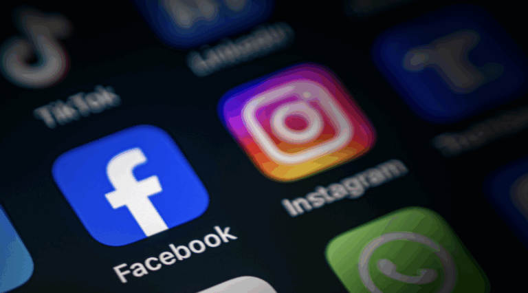 Blurred photo of a phone screen focused on social media apps on a black background | Daniel Stark Injury Lawyers