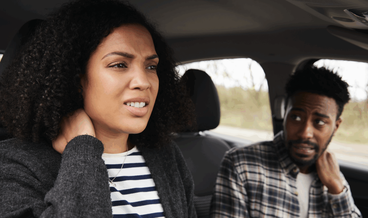 Injured passenger and driver experiencing neck pain following a crash | Daniel Stark Injury Lawyers