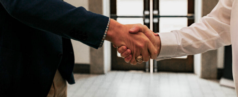 Legal professionals building a referral relationship with a handshake | Daniel Stark Injury Lawyers