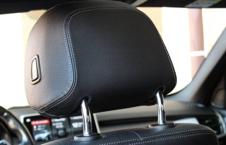 Adjustable headrest in a black leather car seat | Daniel Stark Injury Lawyers