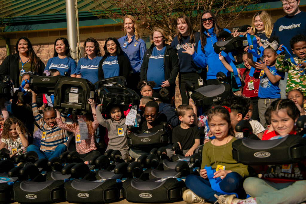 Daniel Stark Injury Lawyers pictured with La Vega ISD students and staff at child passenger safety event in Waco, Texas | Daniel Stark Injury Lawyers