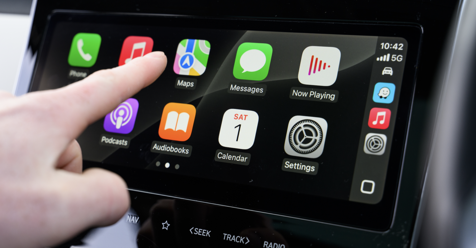 Close-up of Apple CarPlay screen interaction inside a modern vehicle | Daniel Stark Injury Lawyers