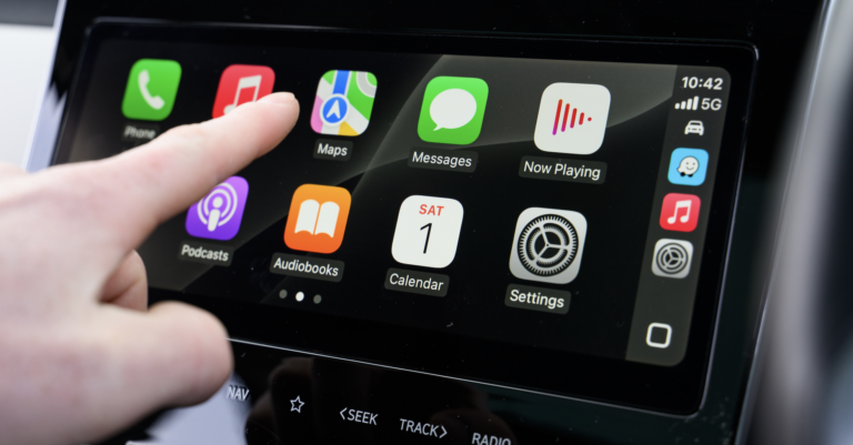 Close-up of Apple CarPlay screen interaction inside a modern vehicle | Daniel Stark Injury Lawyers