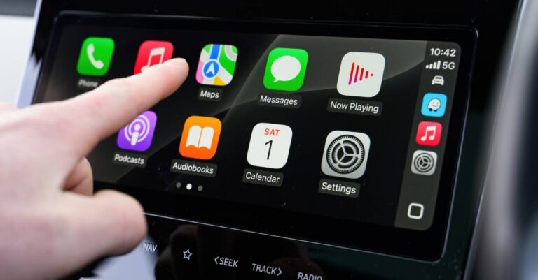 Close-up of Apple CarPlay screen interaction inside a modern vehicle | Daniel Stark Injury Lawyers