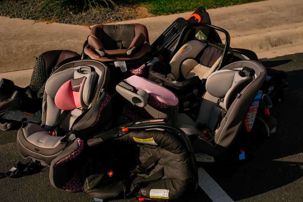 Pile of discarded child safety seats collected after families received new replacement car seats at the Killeen car seat safety event | Daniel Stark Injury Lawyers