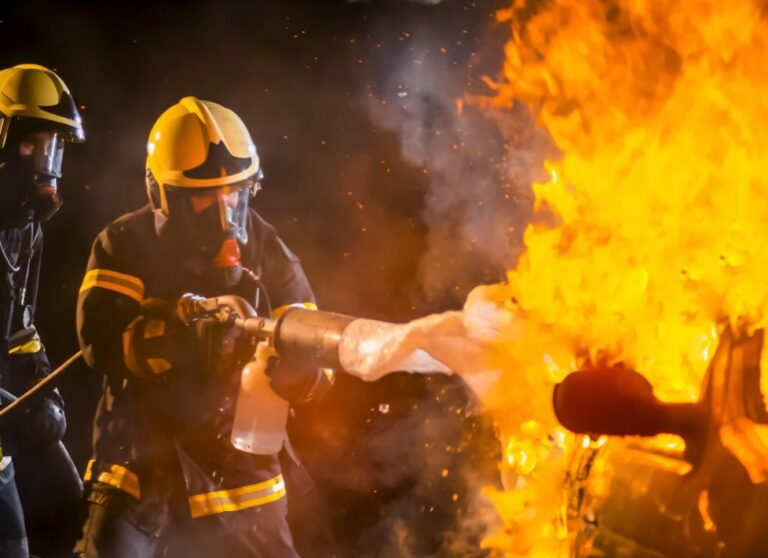 Firefighters extinguishing flames from a car with AFFF Foam | Daniel Stark Injury Lawyers