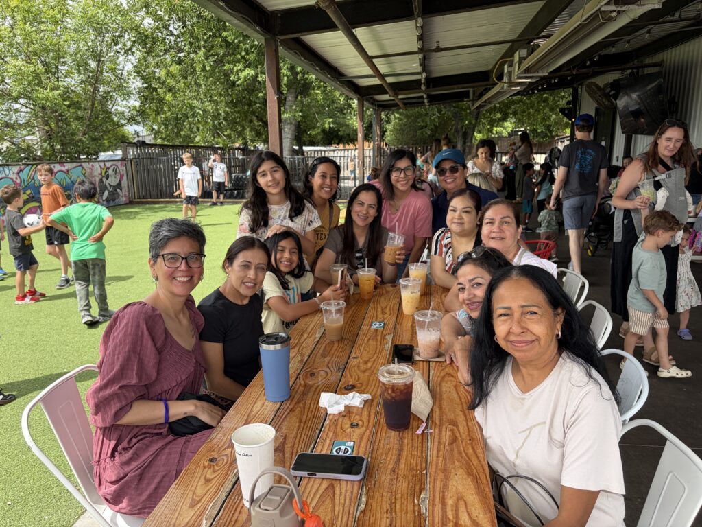 Women gathered around the table at Waco Moms Coffee & Community Event | Daniel Stark Injury Lawyers